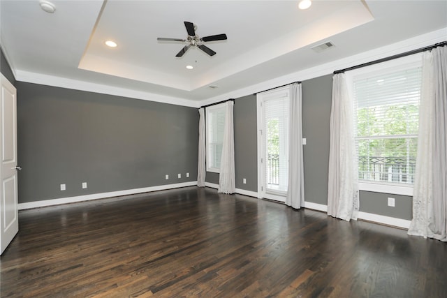 unfurnished room featuring wood finished floors, baseboards, recessed lighting, a raised ceiling, and a ceiling fan