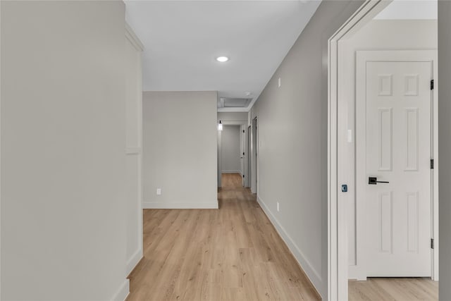 hall featuring light wood-style floors, recessed lighting, and baseboards