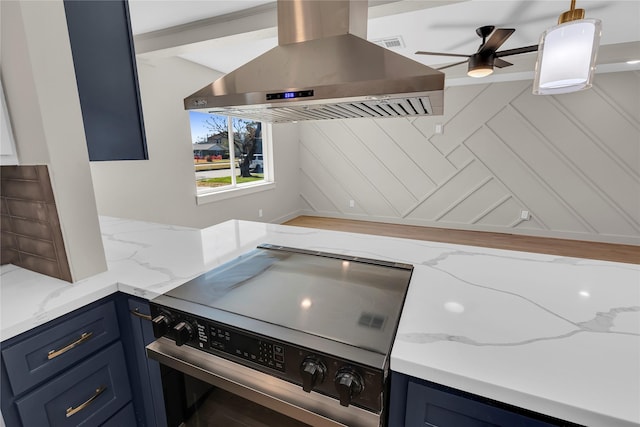 kitchen with light stone countertops, extractor fan, a ceiling fan, stainless steel range oven, and blue cabinets