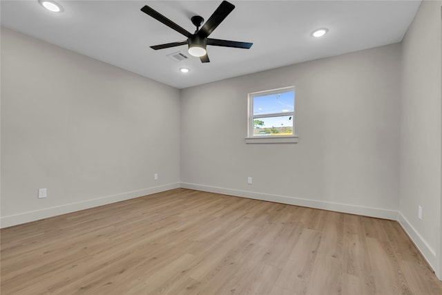 unfurnished room featuring baseboards, visible vents, ceiling fan, and light wood-type flooring