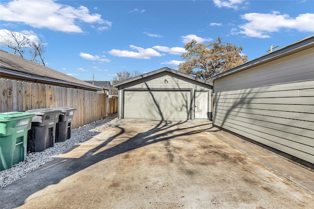 detached garage featuring fence