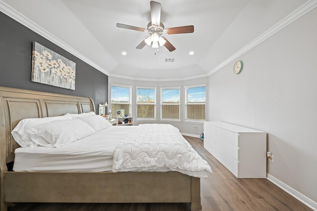 bedroom with ceiling fan, visible vents, wood finished floors, baseboards, and ornamental molding