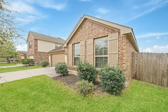 view of side of property featuring brick siding, an attached garage, fence, and concrete driveway