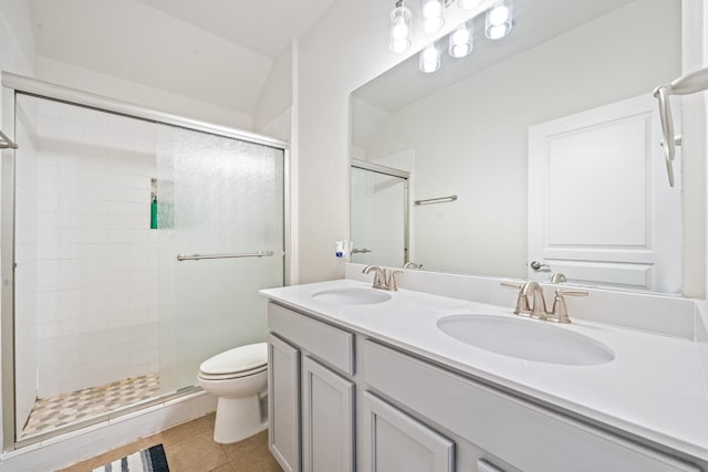 bathroom with toilet, tile patterned floors, a shower stall, and a sink