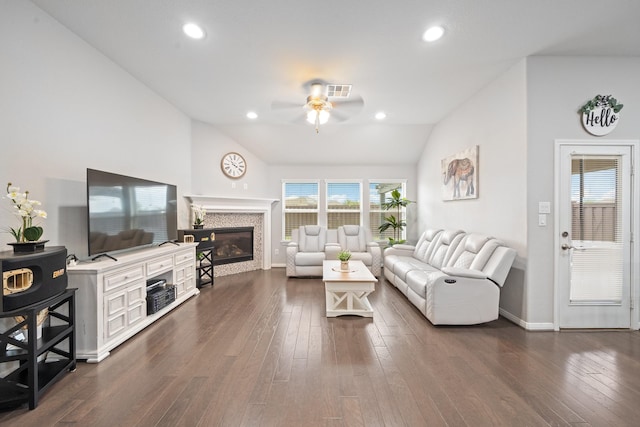 living room featuring ceiling fan, a glass covered fireplace, dark wood finished floors, recessed lighting, and vaulted ceiling