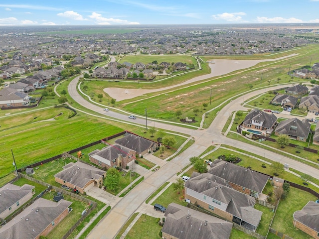 bird's eye view with a residential view and a water view