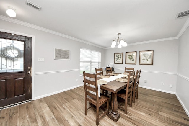 15519 Hensen Creek Dr, Houston, TX 77086 - dining room with a chandelier, wood finished floors, baseboards, and ornamental molding