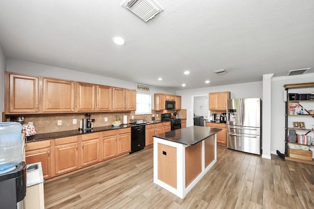 15519 Hensen Creek Dr, Houston, TX 77086 - kitchen with black appliances, dark countertops, a sink, light wood-style floors, and recessed lighting