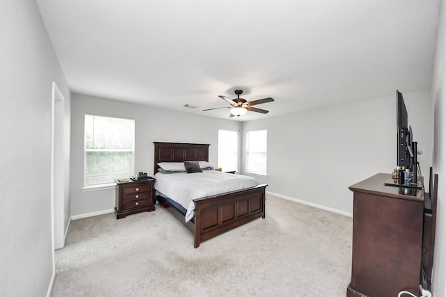 15519 Hensen Creek Dr, Houston, TX 77086 - bedroom featuring light colored carpet, baseboards, and ceiling fan