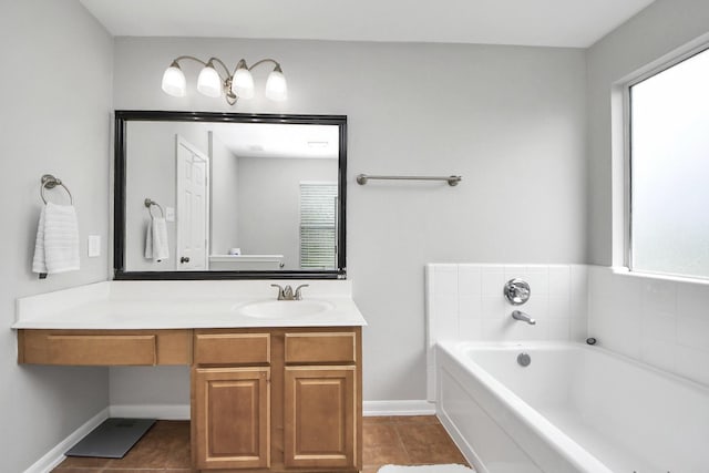 15519 Hensen Creek Dr, Houston, TX 77086 - bathroom with a garden tub, vanity, tile patterned flooring, and baseboards