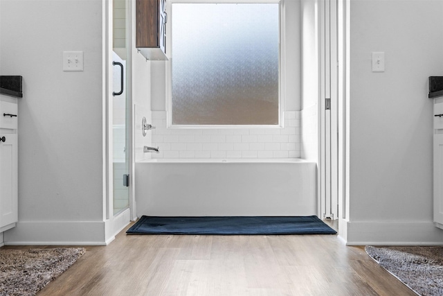 interior space with baseboards and wood finished floors
