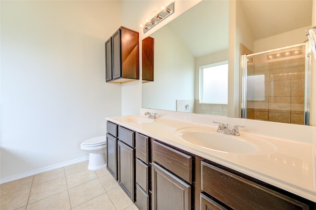 full bath with a sink, tile patterned flooring, a shower stall, and toilet