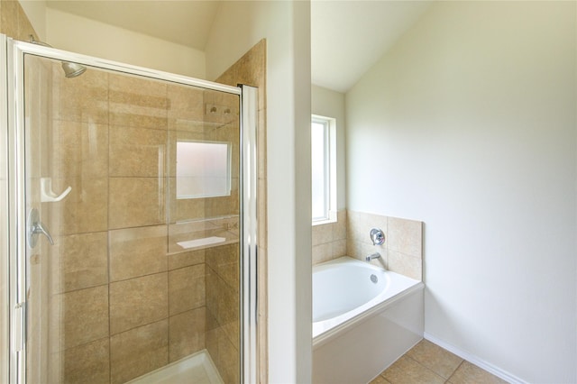 full bath featuring tile patterned floors, a shower stall, a garden tub, and lofted ceiling