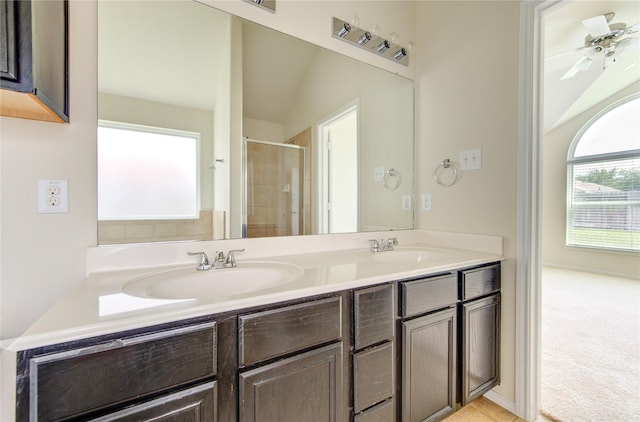 full bathroom with a sink, a stall shower, and double vanity