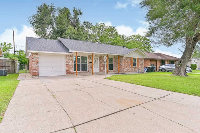ranch-style home featuring brick siding, an attached garage, a front yard, and concrete driveway