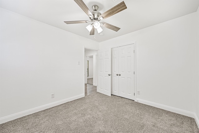 unfurnished bedroom featuring a closet, baseboards, and carpet flooring