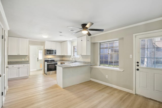 6531 Coral Ridge Rd, Houston, TX 77069 - kitchen with crown molding, appliances with stainless steel finishes, white cabinets, and a sink