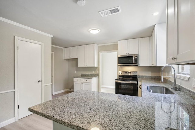 6531 Coral Ridge Rd, Houston, TX 77069 - kitchen with a sink, light stone counters, stainless steel appliances, and visible vents