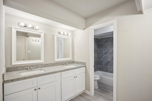6531 Coral Ridge Rd, Houston, TX 77069 - full bathroom with double vanity, a sink, wood finished floors, and toilet