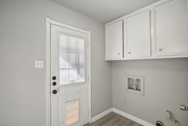 6531 Coral Ridge Rd, Houston, TX 77069 - laundry area featuring wood finished floors, baseboards, cabinet space, washer hookup, and hookup for an electric dryer