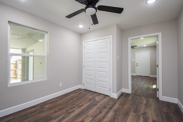 unfurnished bedroom with baseboards, recessed lighting, dark wood-style flooring, and a closet