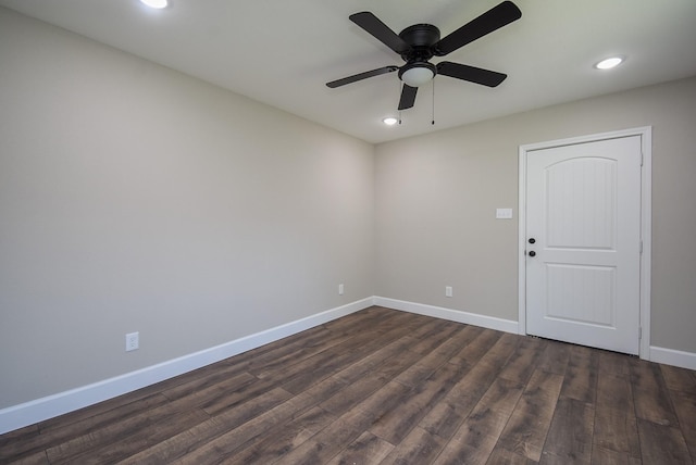 spare room featuring baseboards, dark wood-style flooring, a ceiling fan, and recessed lighting