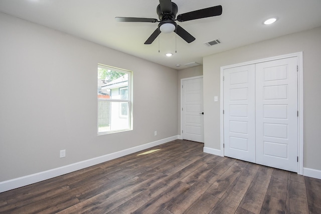 unfurnished bedroom with dark wood-style flooring, visible vents, baseboards, a closet, and recessed lighting