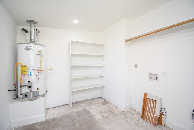 clothes washing area with baseboards, laundry area, washer hookup, and gas water heater