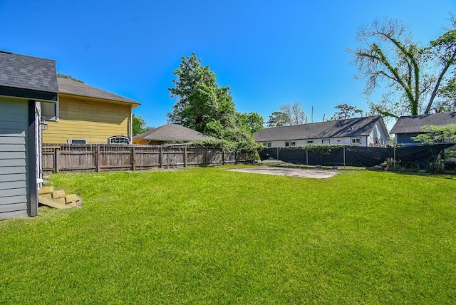 view of yard with a fenced backyard and a patio
