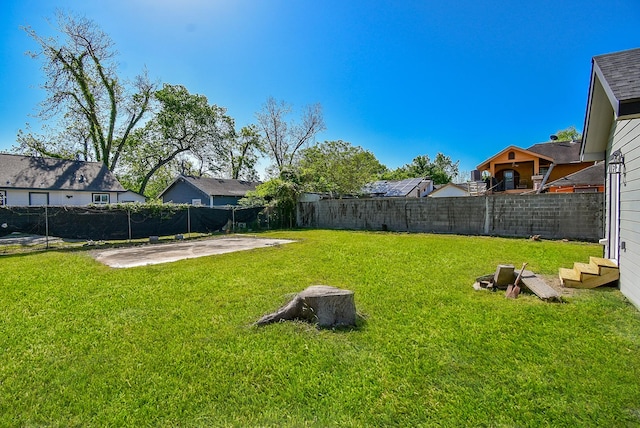 view of yard featuring a patio, a residential view, and a fenced backyard