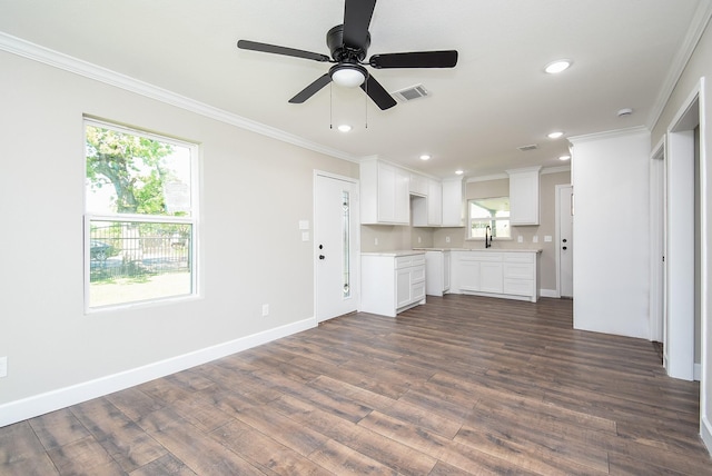 unfurnished living room with crown molding, dark wood-style flooring, recessed lighting, and a healthy amount of sunlight