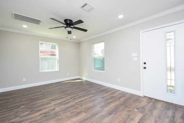unfurnished room with visible vents, dark wood finished floors, ceiling fan, and a healthy amount of sunlight