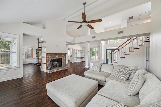 living area featuring ceiling fan, stairs, wood finished floors, and visible vents