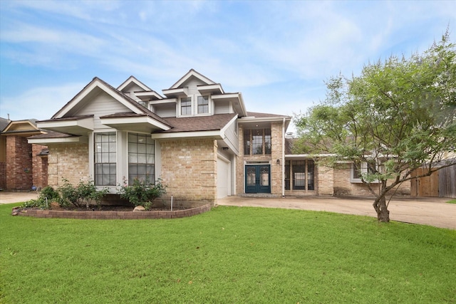 traditional home with roof with shingles, a garage, brick siding, a front lawn, and concrete driveway