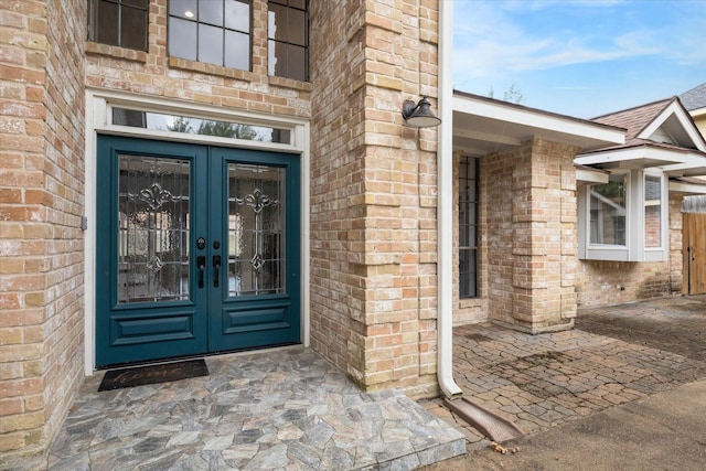 property entrance with french doors and brick siding
