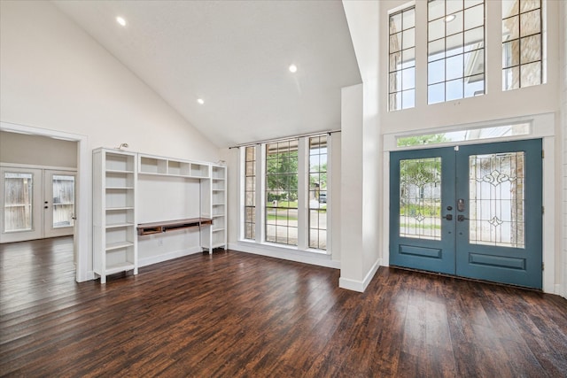 entryway with wood finished floors, baseboards, high vaulted ceiling, recessed lighting, and french doors