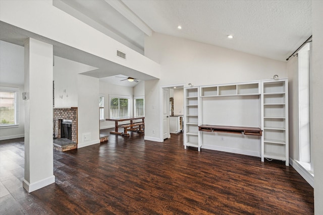 living area featuring visible vents, wood finished floors, ceiling fan, a textured ceiling, and vaulted ceiling