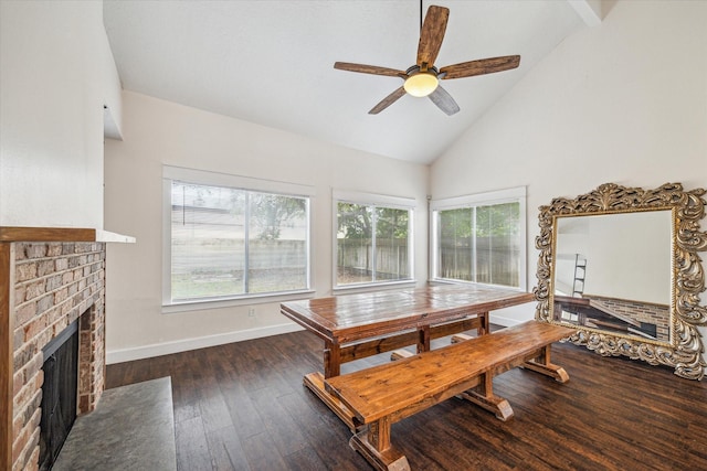 dining room with baseboards, a brick fireplace, wood finished floors, and a wealth of natural light