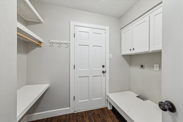 mudroom featuring baseboards, dark wood-style floors, and a textured ceiling