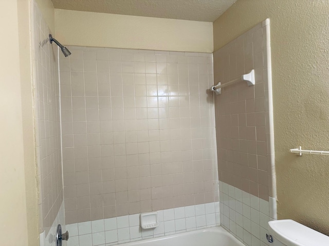 full bathroom featuring a textured wall, bathtub / shower combination, and toilet