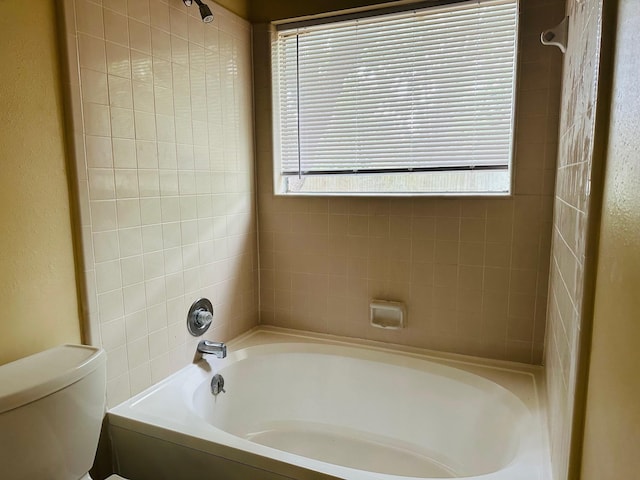bathroom featuring a shower, toilet, a tub to relax in, and a wealth of natural light