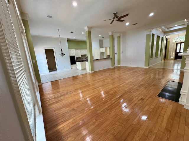 unfurnished living room featuring crown molding, recessed lighting, a ceiling fan, and light wood finished floors