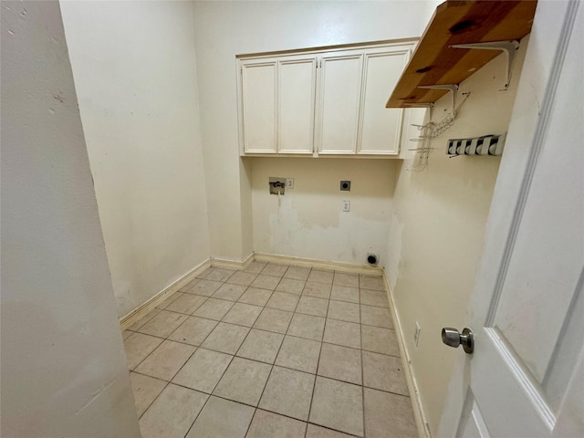 laundry area featuring light tile patterned flooring, baseboards, electric dryer hookup, cabinet space, and washer hookup