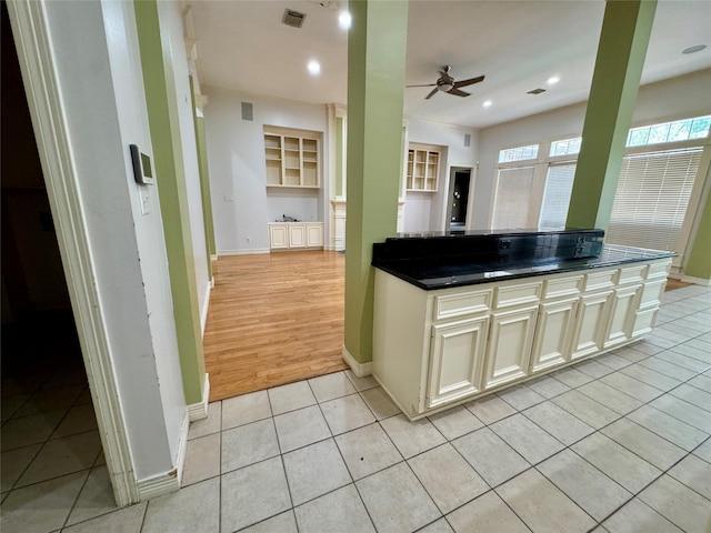 kitchen featuring visible vents, baseboards, and dark countertops
