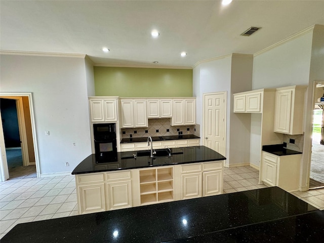 kitchen featuring crown molding, baseboards, tasteful backsplash, visible vents, and black appliances