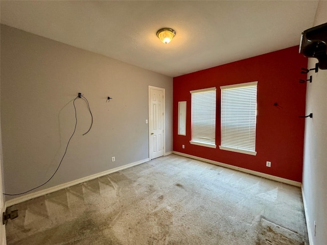 empty room with carpet floors and baseboards