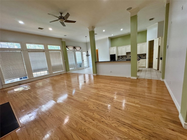unfurnished living room with ceiling fan, visible vents, light wood-type flooring, baseboards, and recessed lighting