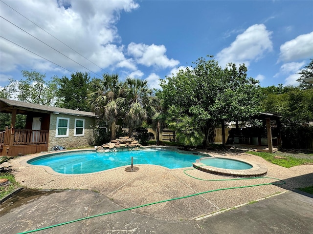 view of pool with a pool with connected hot tub and a patio area