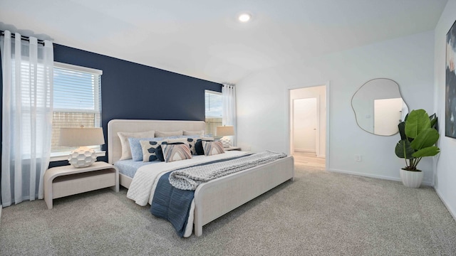 bedroom with baseboards, carpet, vaulted ceiling, and multiple windows