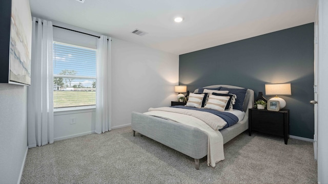 bedroom featuring baseboards, visible vents, and carpet